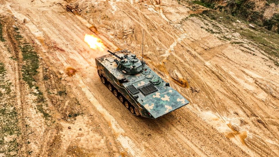 Armored vehicles fire at targets  