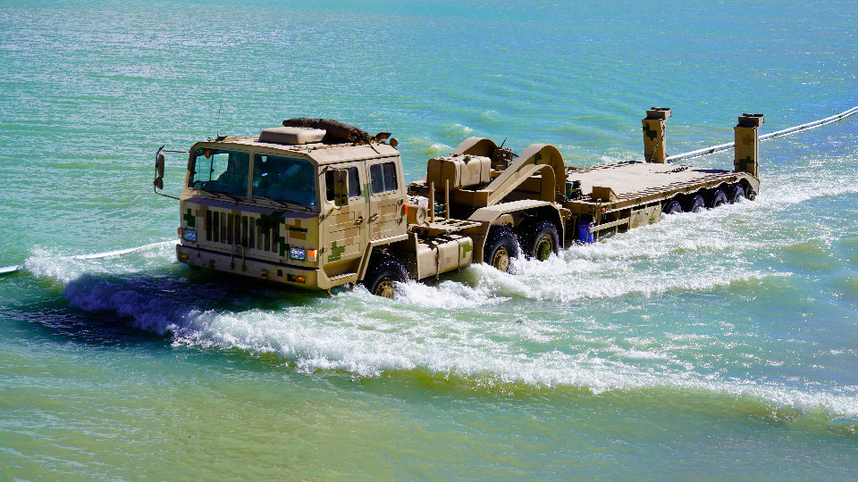 TA4360 heavy equipment transport vehicles wade through water area