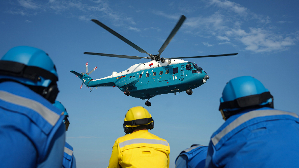 Ship-borne helicopter takes off during maritime training