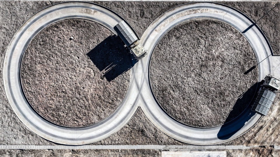 Military trucks maneuver on training ground