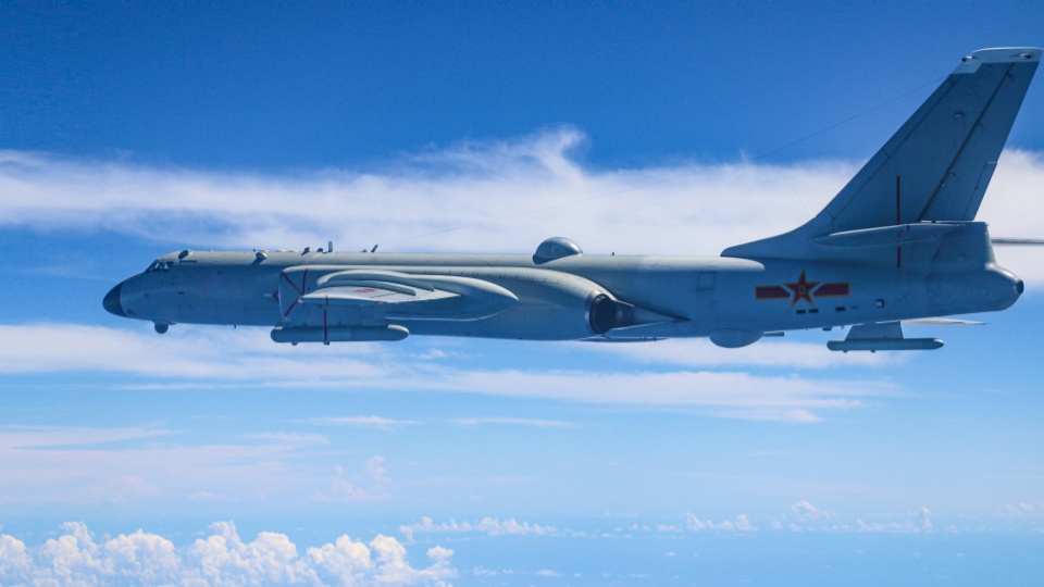 H6 bomber flies over clouds