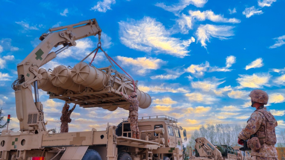 Soldiers hoist and load HQ-16 air defense missile system 
