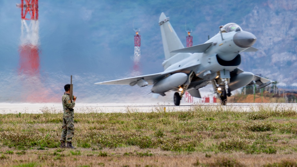 Bird control soldier safeguards J-10C fighter jet flight