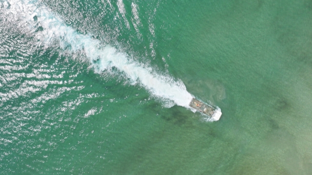 Amphibious armored vehicles conduct combat training
