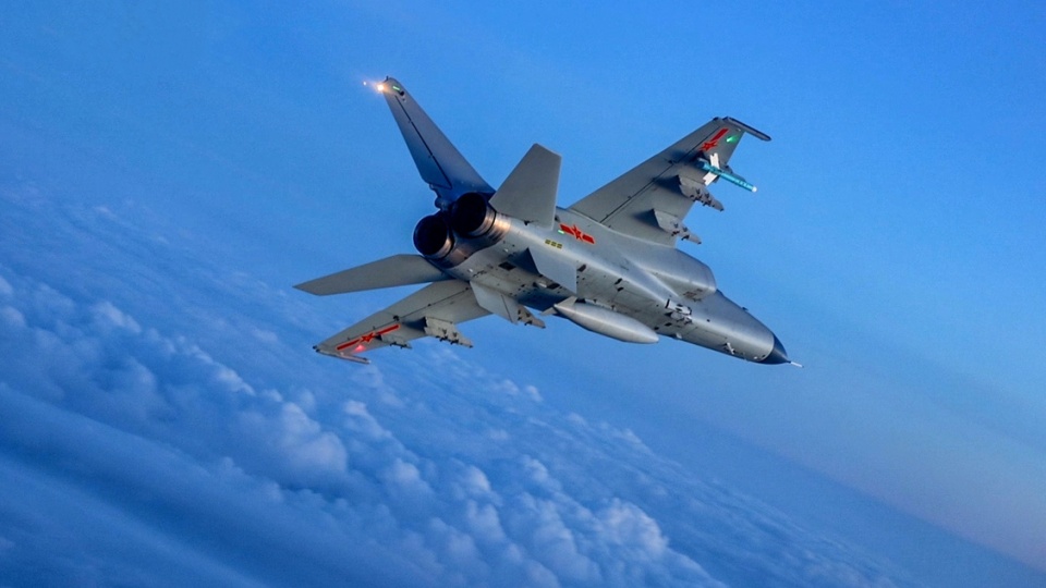 JH-7 fighter bomber flies above clouds