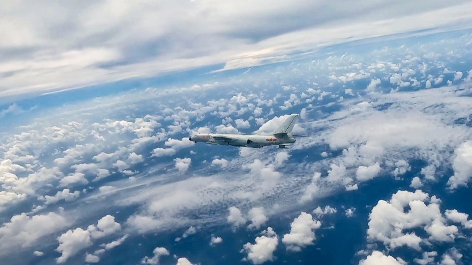 H-6 bomber flies over clouds