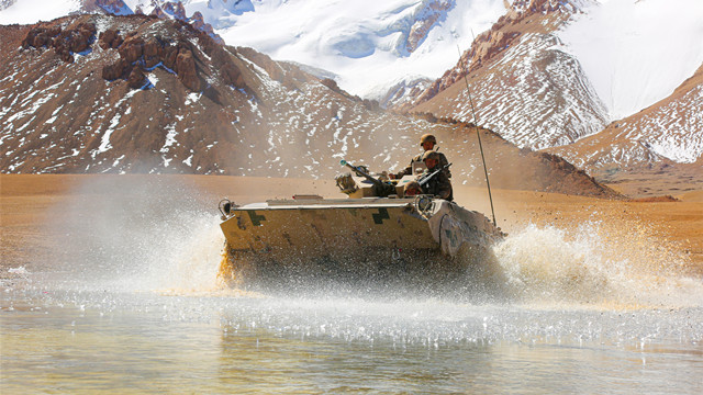 Armored vehicle wades through water obstacle