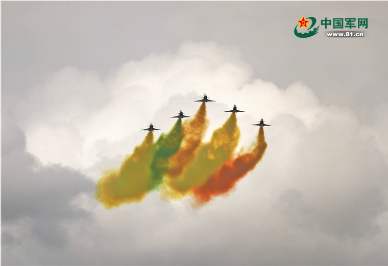The PLA Air Force's Bayi Aerobatics Team is performing an aerobatic stunt at the opening ceremony of the Singapore Airshow.